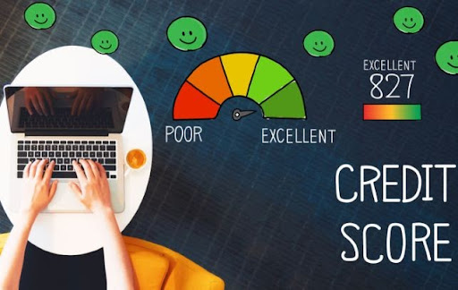 Hand using laptop to check credit score with thoughts of excellent score