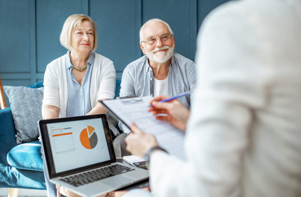 Couple discussing about credit score with professional in office area regarding credit score