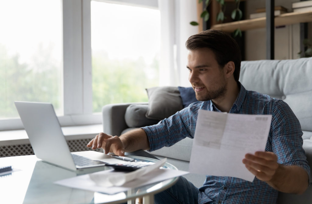 Young man looking at blue copper capital websites in regards to personal loan and learn more about it