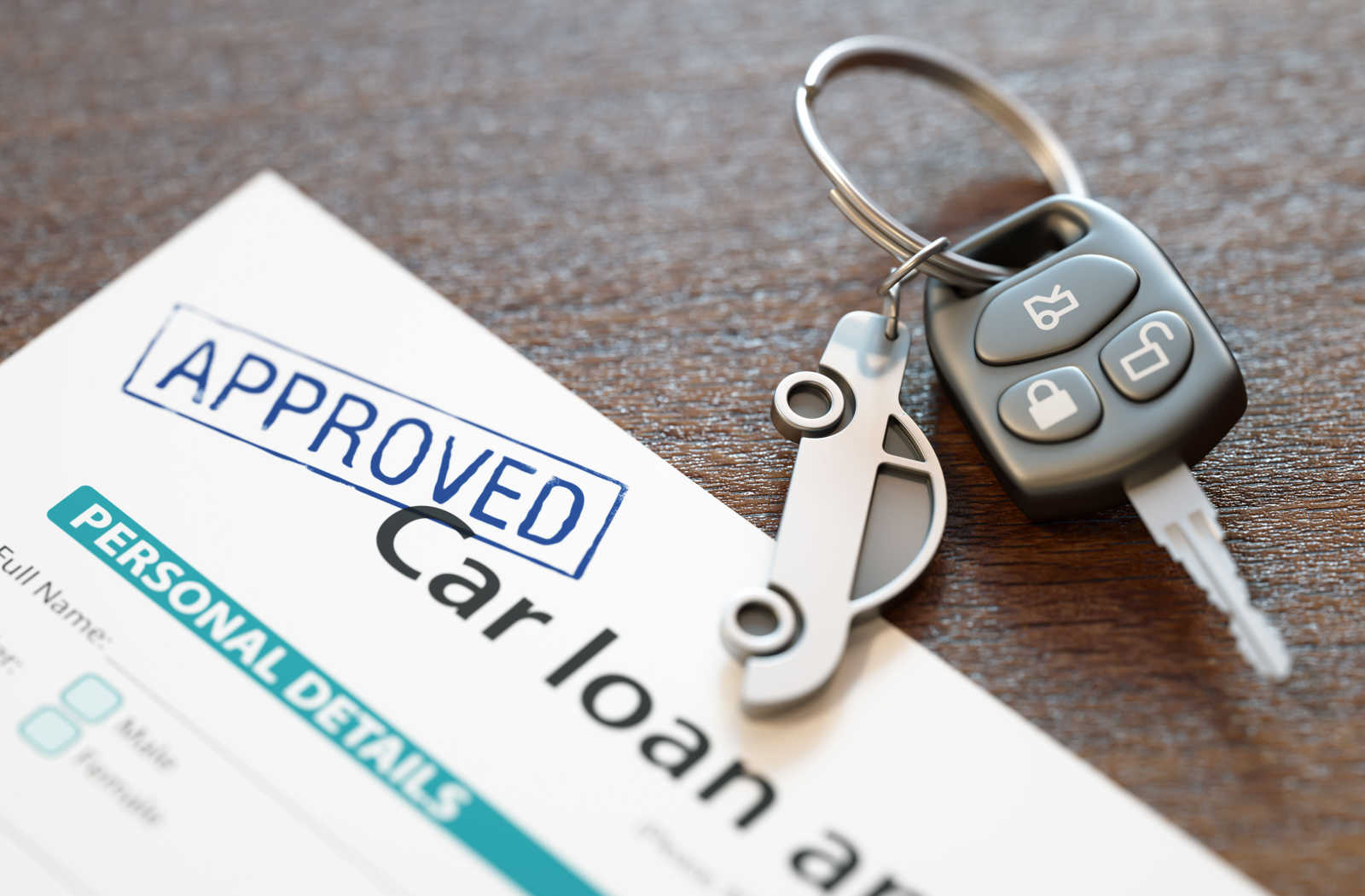 A car loan approval papers placed on a table with car keys next to it.