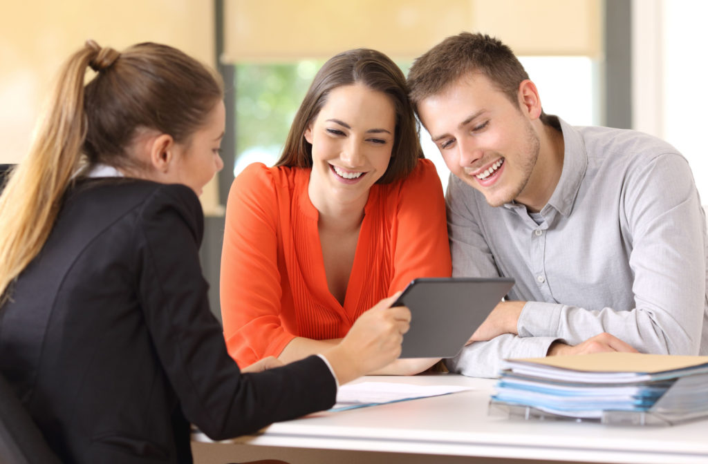 A man and a woman getting financial advice from a female loan officer.