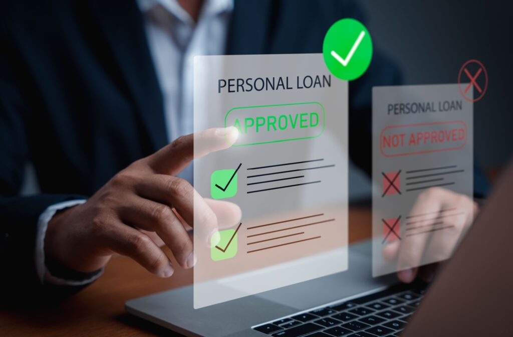 Close-up of a person in a suit pointing at a holographic display showing an approved personal loan next to a declined personal loan.