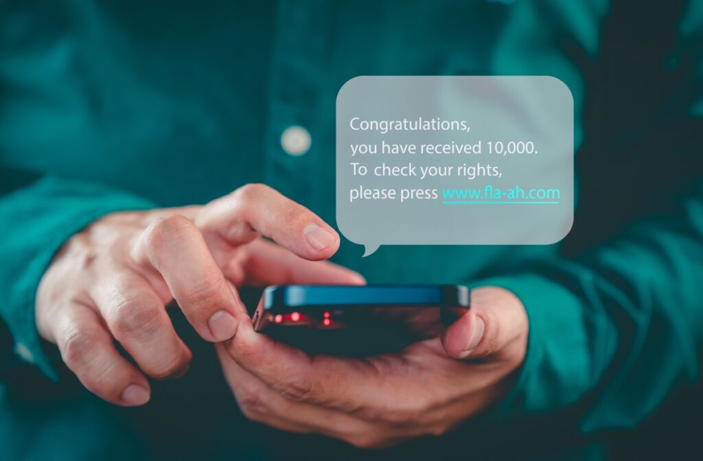 A person receives a scam text on their smartphone.