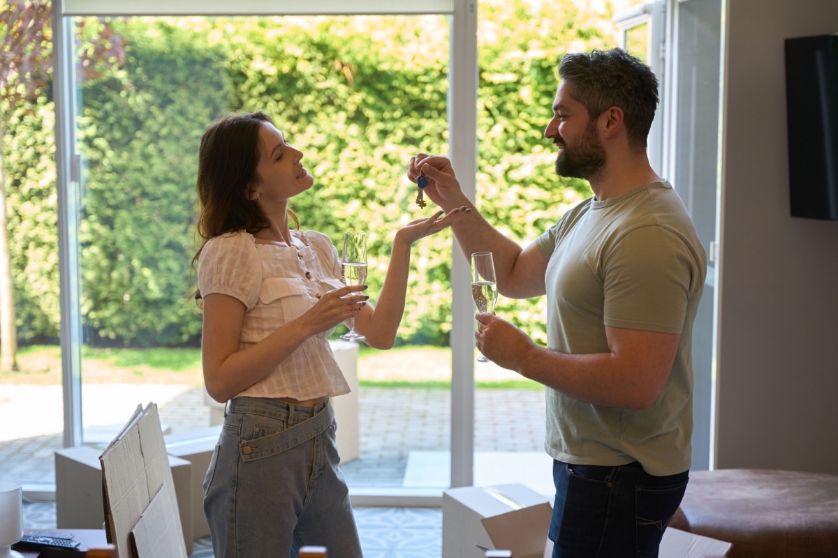 A couple celebrating buying a home after planning a financial future together.