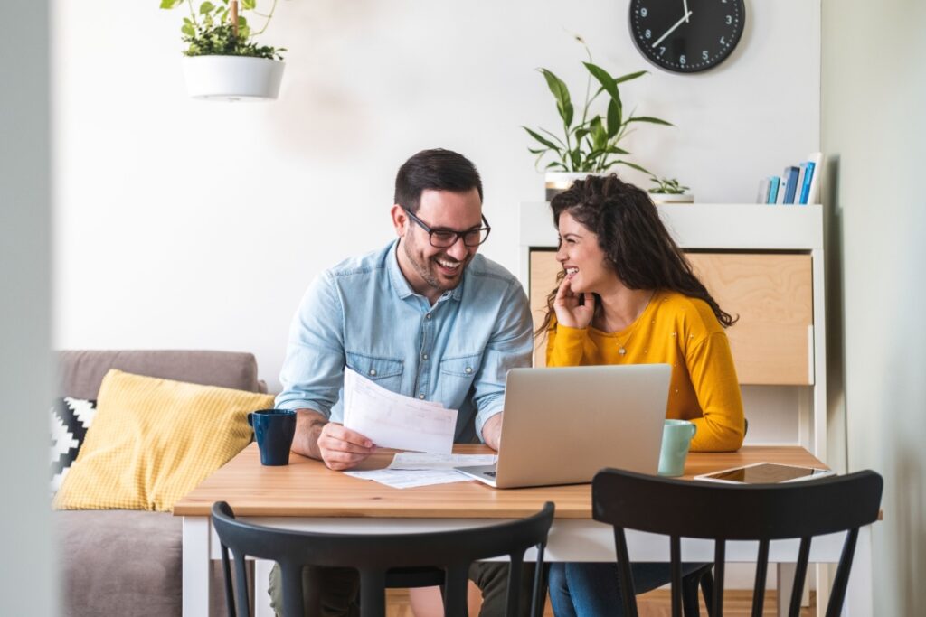 A couple sitting at a table discussing finances.