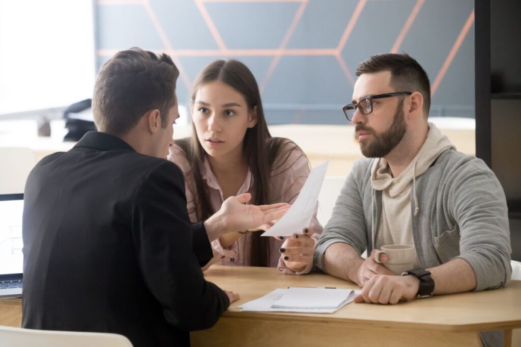 A couple having a discussion about loans with a financial advisor.